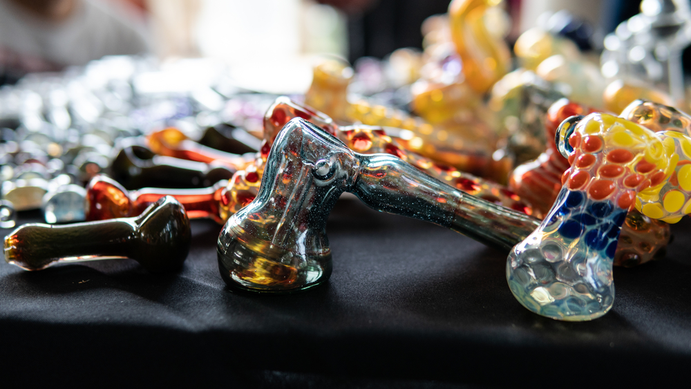 glass smoking pipes on a black background. Design accessories fo