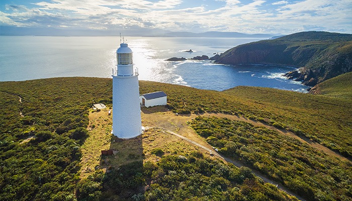 The Cape Bruny Lighthouse on Bruny Island overlooking the rugged coastline and Southern Ocean in Tasmania.